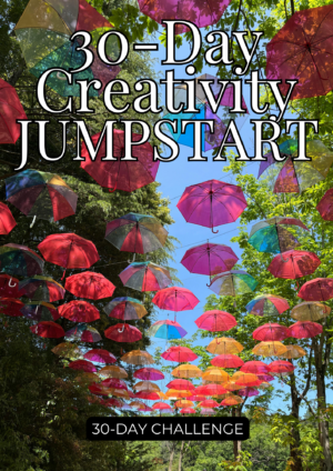 Colorful umbrellas suspended overhead in an outdoor walkway lined with green trees under a bright blue sky, with text overlay reading “30-Day Creativity Jumpstart” and “30-Day Challenge.