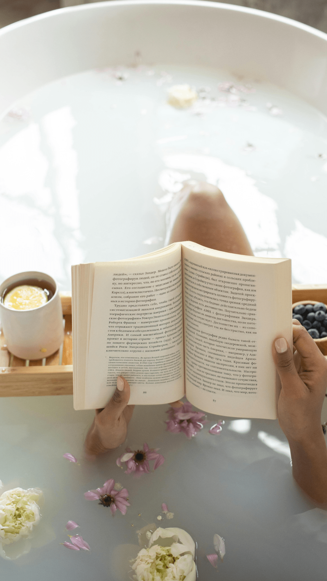 woman relaxing while reading in the bath