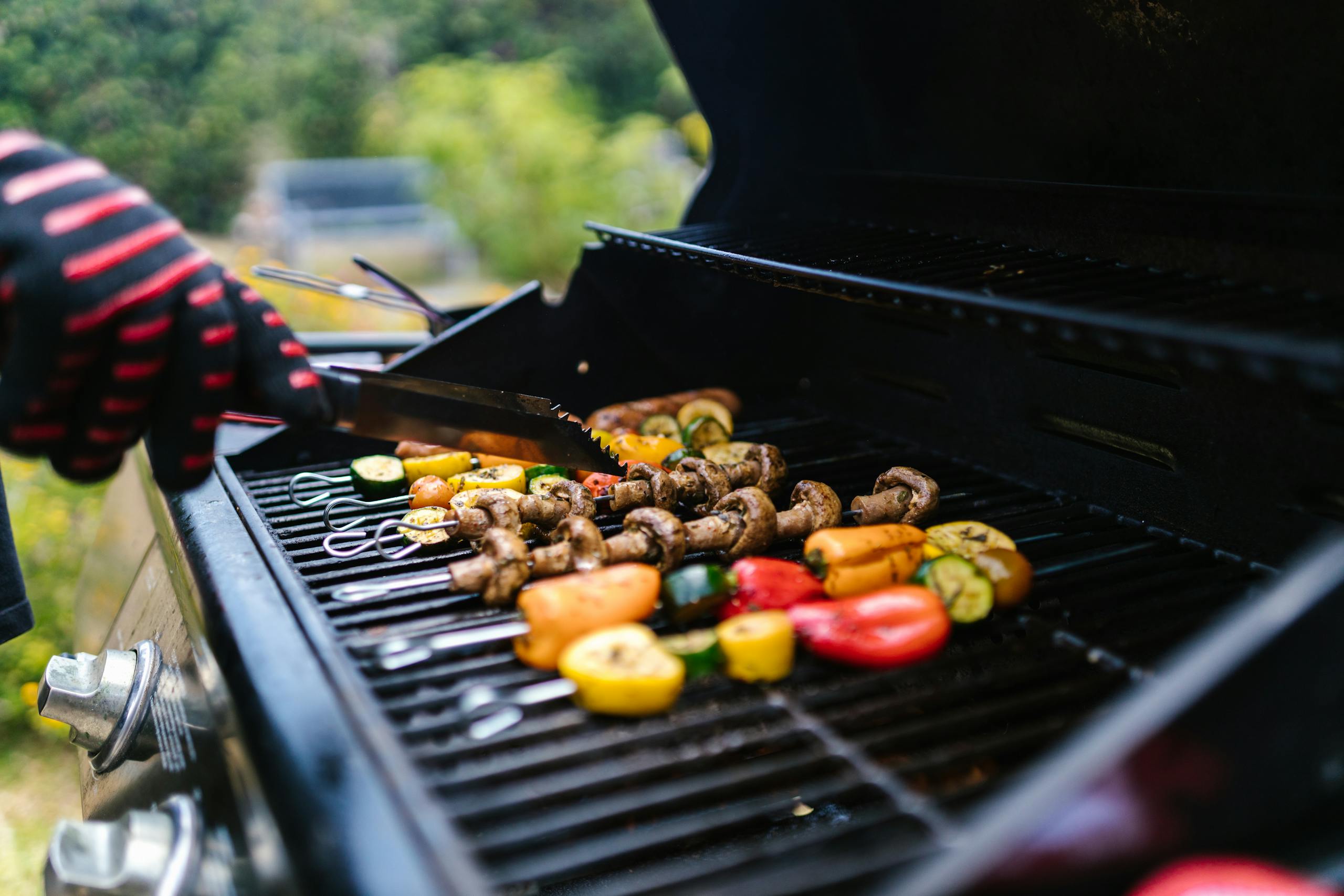 Grilled vegetables being cooked on an outdoor barbecue on a summer day.