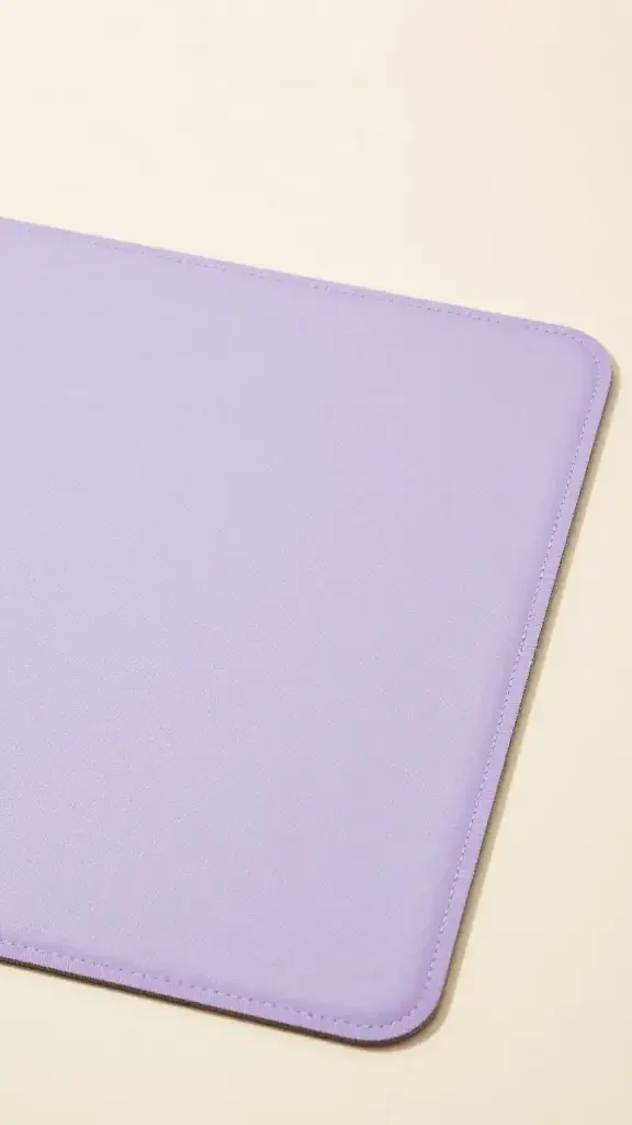 closeup of lavender desk mat with creamy workspace backdrop