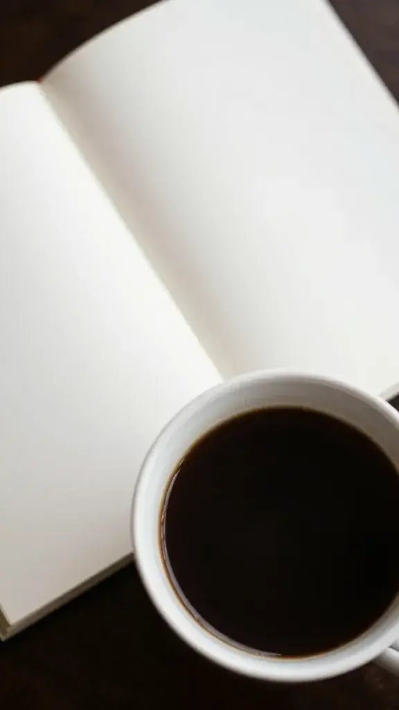 closeup of a single coffee cup with empty agenda pages in the background, trying to find a boredom cure.