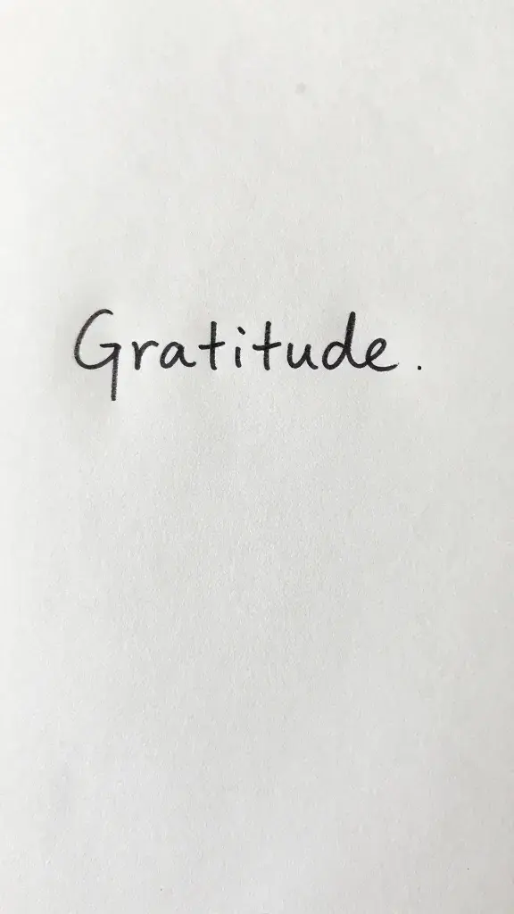 Closeup of a handwritten gratitude note on plain paper