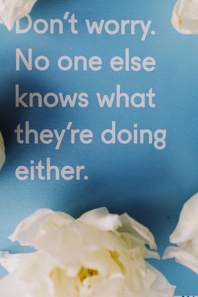 A motivational quote on a blue background with white flowers, offering encouragement.