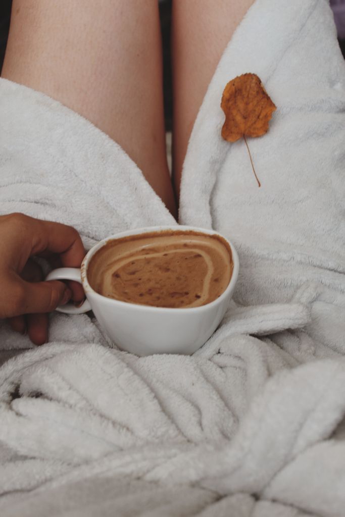 A warm NOVEMBER SELF CARE SESSION wrapped in a bathrobe, holding coffee, and appreciating the fall leaves.