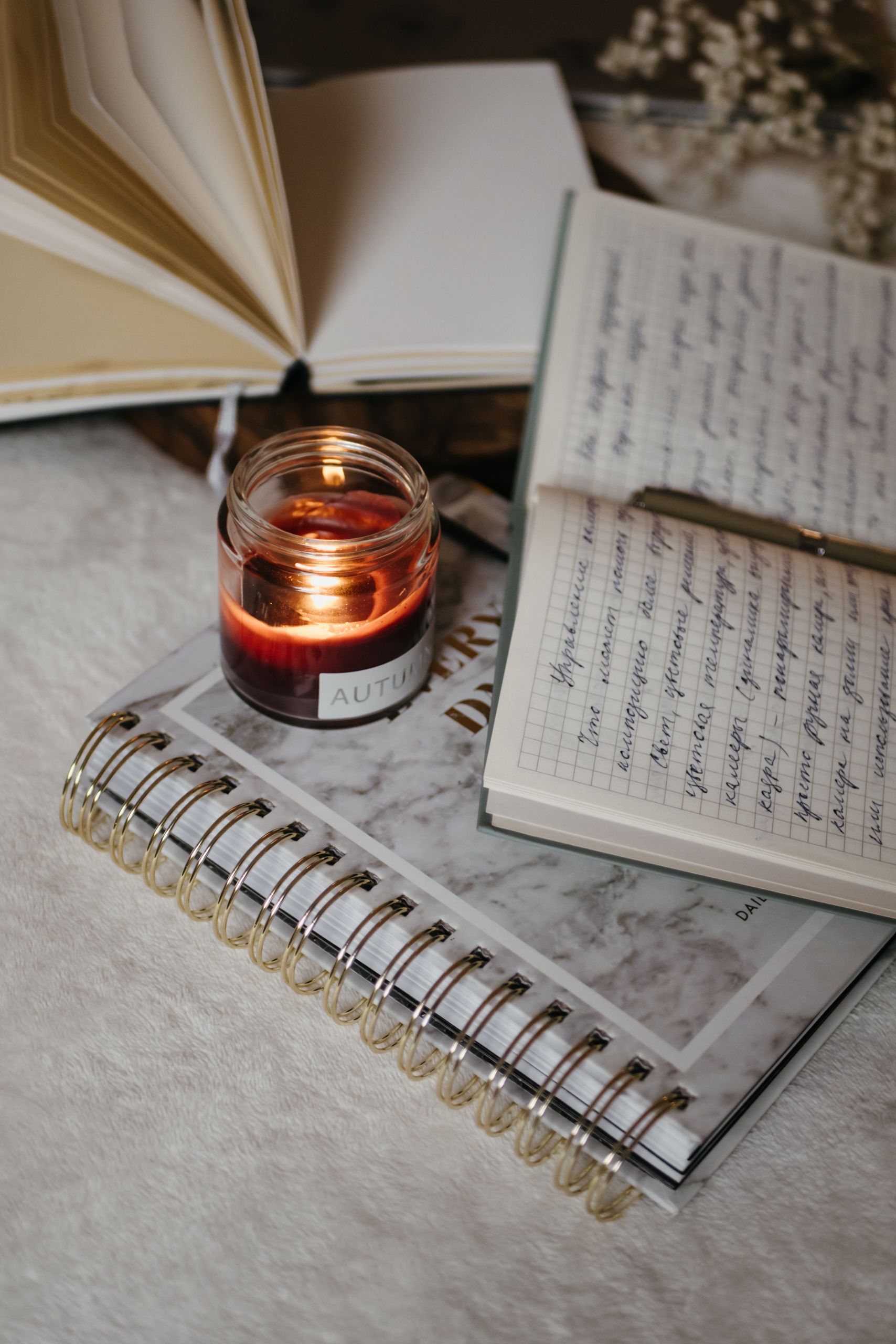 A warm candlelight scene with open journals and handwritten notes, perfect for study or reflection.