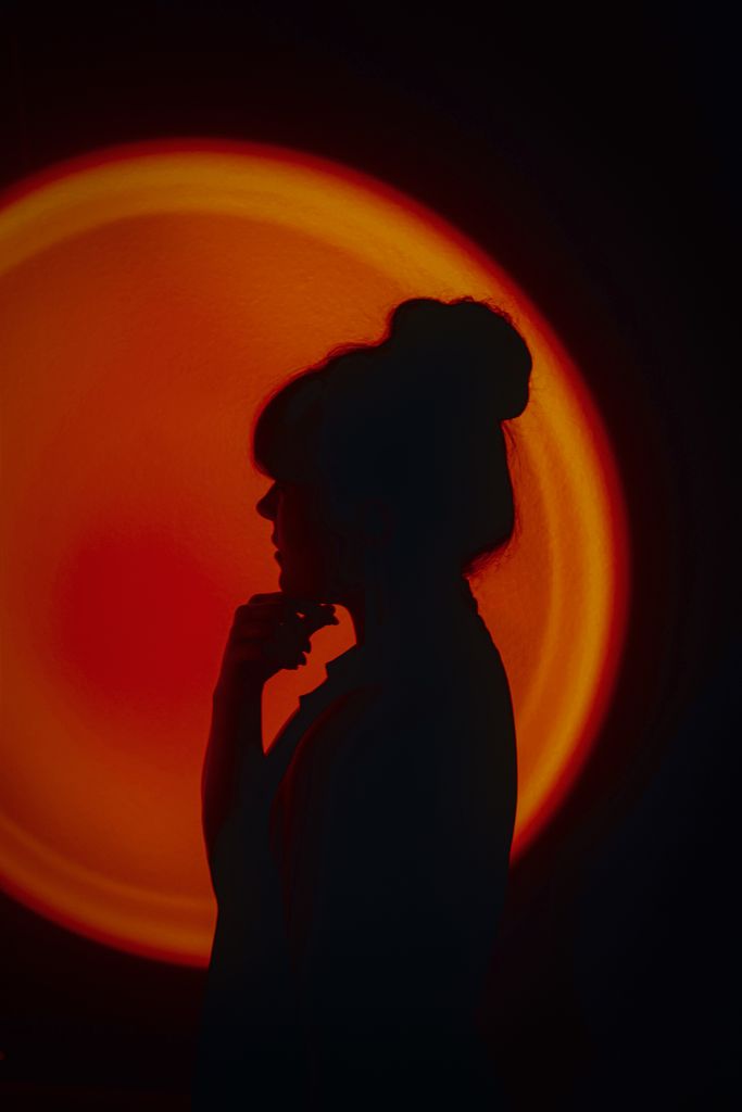Artistic silhouette of a woman with creative, vibrant lighting for unique photography. that girl glow up