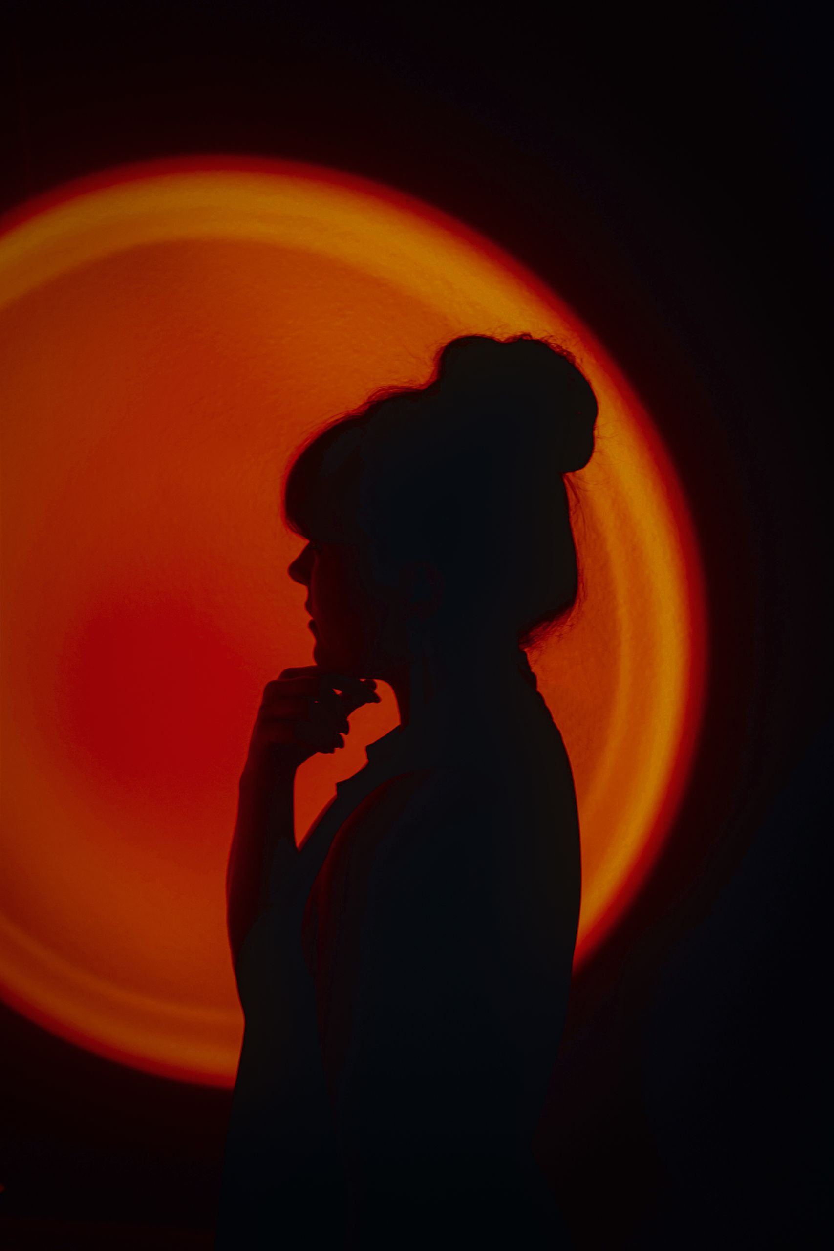 Artistic silhouette of a woman with creative, vibrant lighting for unique photography.