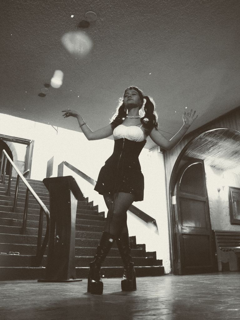 Elegant black and white portrait of a woman dancing indoors with a vintage flair. how to be the main character