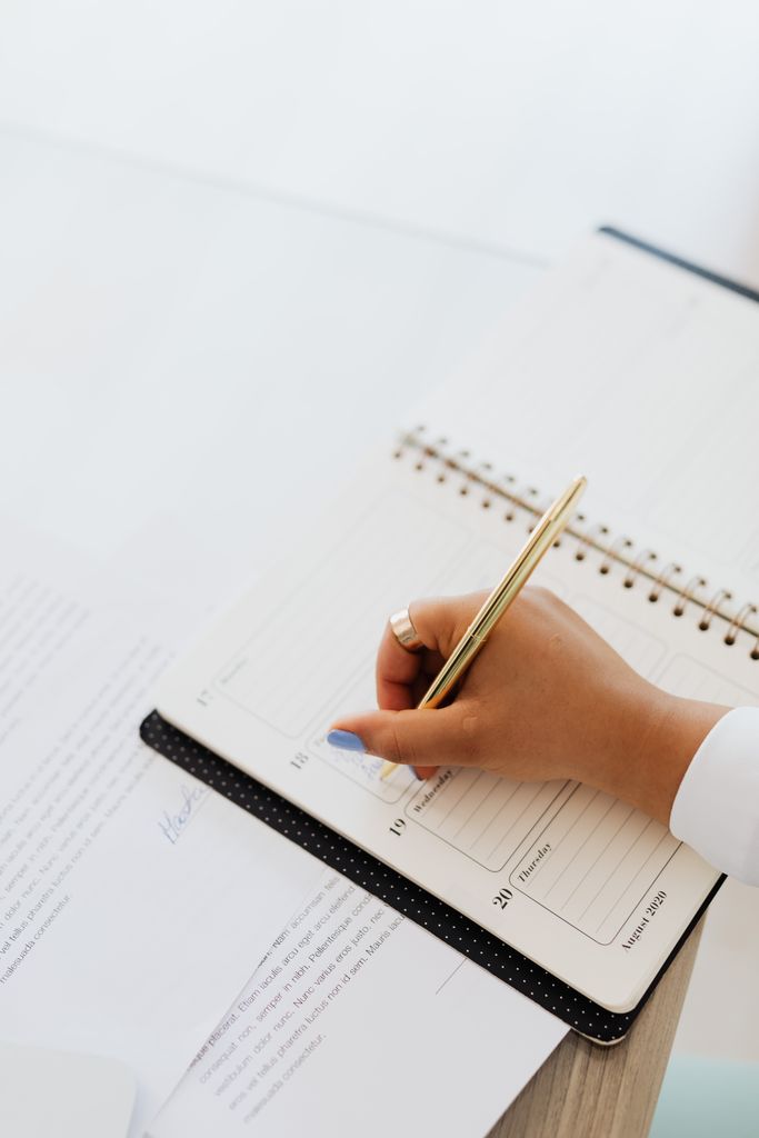 Elegant hand writing plans in a notebook with a pen, perfect for organization themes. best planners